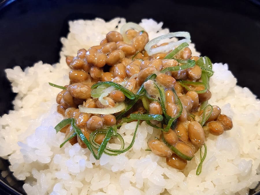 Straw-wrapped Mito natto served with mustard and sliced spring onion.