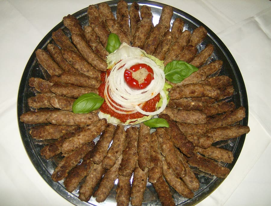 Traditional Bosnian dish set served in copper cookware near Stari Most.