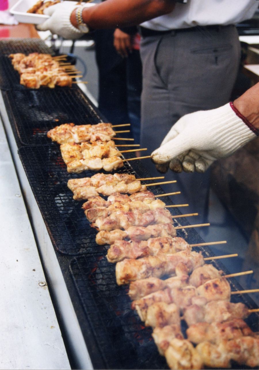 Muroran yakitori features pork shoulder, onions, and yellow mustard.