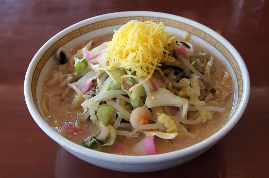 A bowl of Nagasaki Champon topped with cabbage, pork, and local seafood.