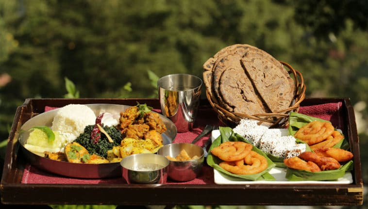 Traditional Kumaoni thali featuring black soybean gravy, spiced potatoes, and hill pulses.