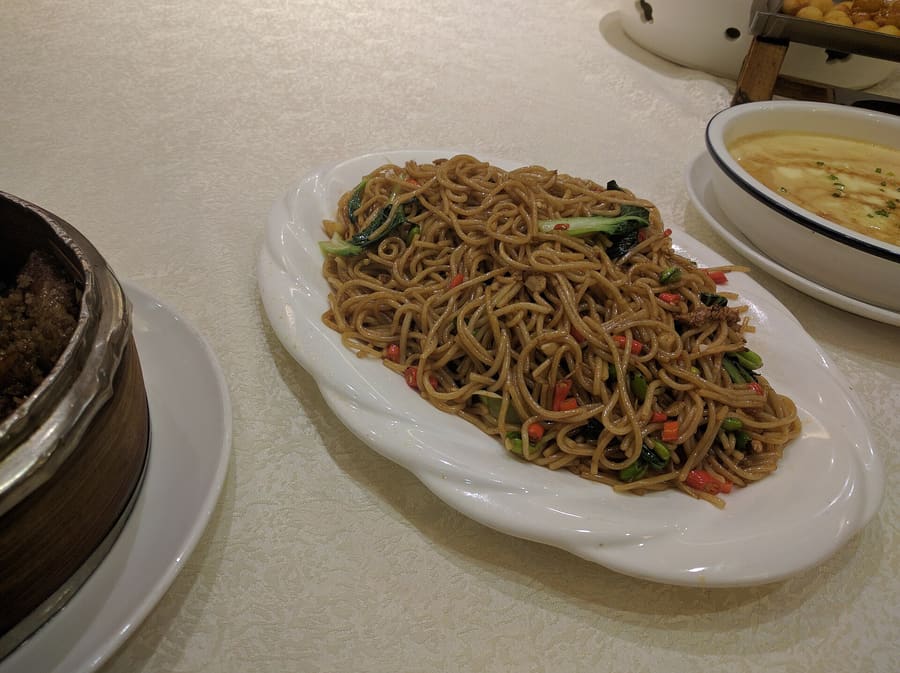 Nanchang fried rice noodles (chao mixian) topped with pickled mustard greens and fresh chilies.