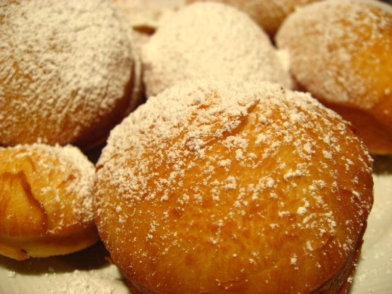Fresh beignets with chicory coffee at a neighborhood counter.