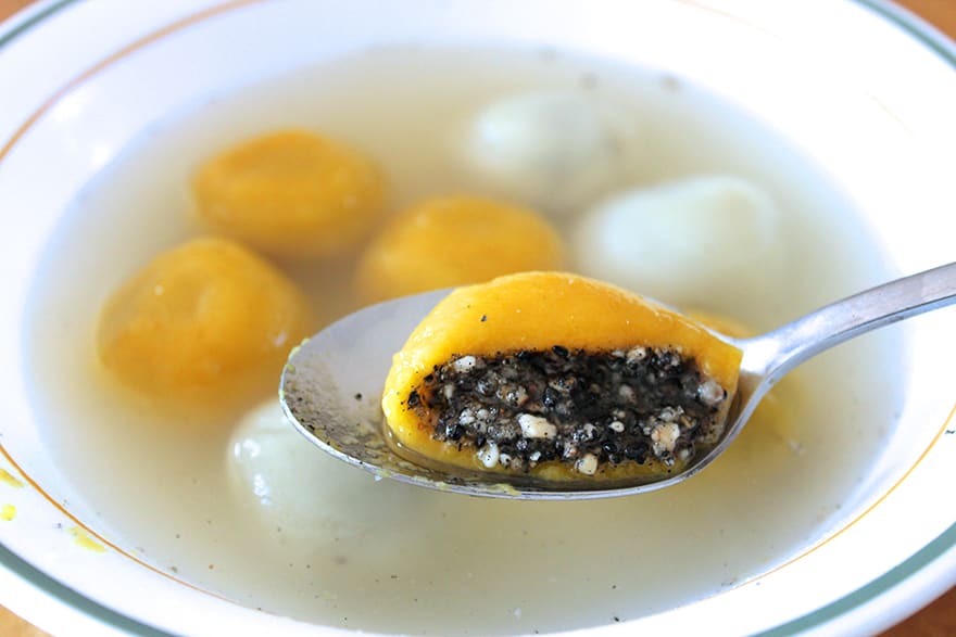 Handmade Ningbo tangyuan served in sweet water with lard-rich black sesame fillings.