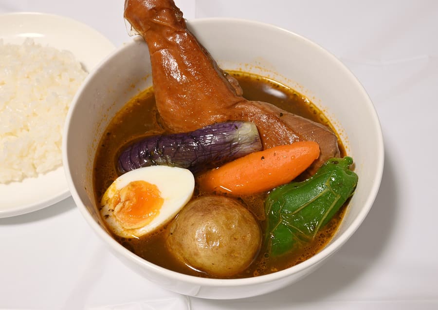 A bowl of Hokkaido soup curry with local vegetables and chicken.