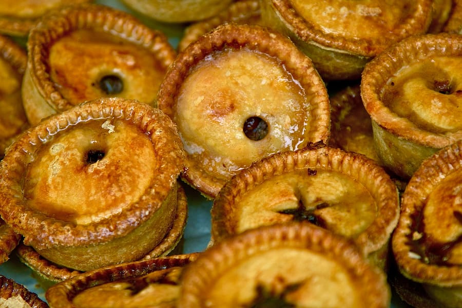 A classic cold pork pie with seasoned meat and jelly, standard bar fare across Nottinghamshire pubs.