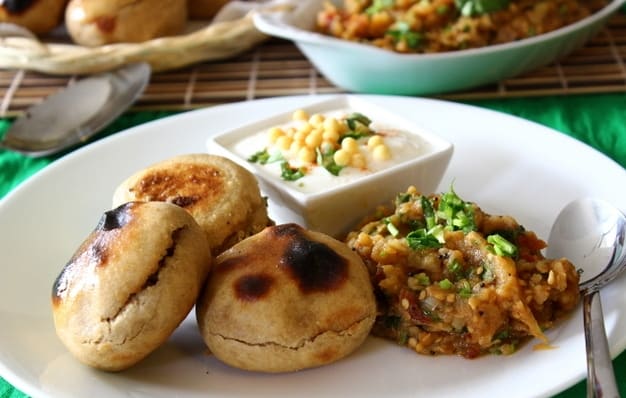 Litti chokha served hot with green chutney and roasted aubergine mash.