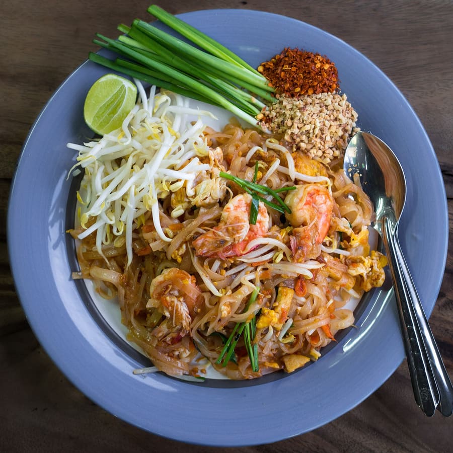 Traditional Sukhothai-style noodles served with crushed peanuts, lime, and long beans.