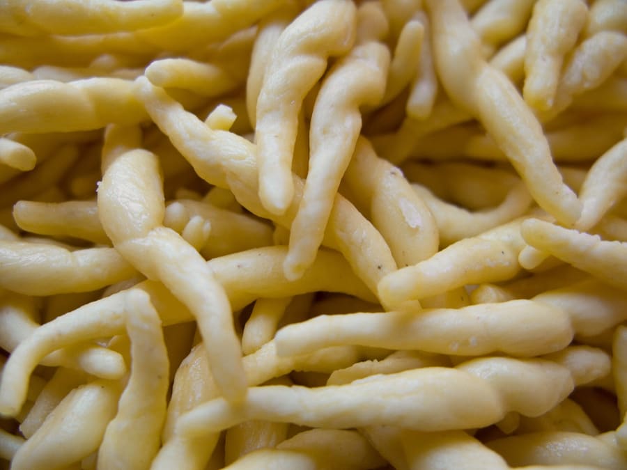 Hand-rolled trofie pasta coated in fresh basil pesto.
