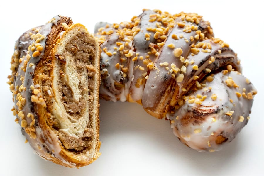 A certified St. Martin croissant, packed with white poppy seed filling and topped with sugar glaze.