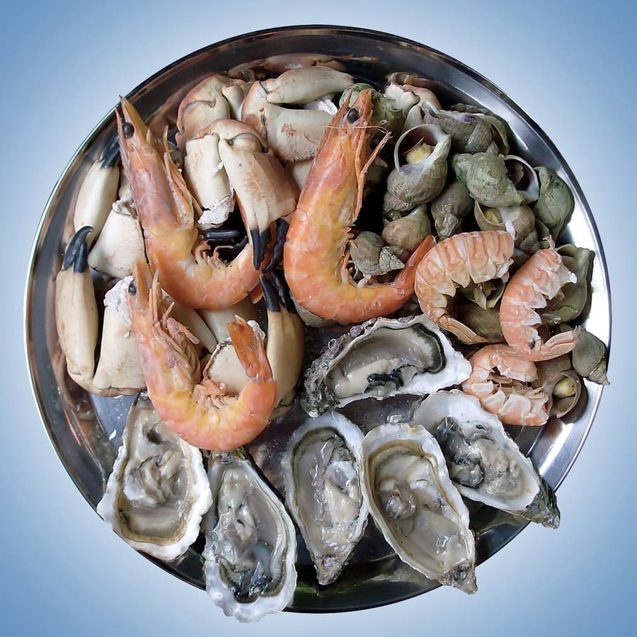 Spicy sautéed clams served alongside unfiltered draft Tsingtao beer.