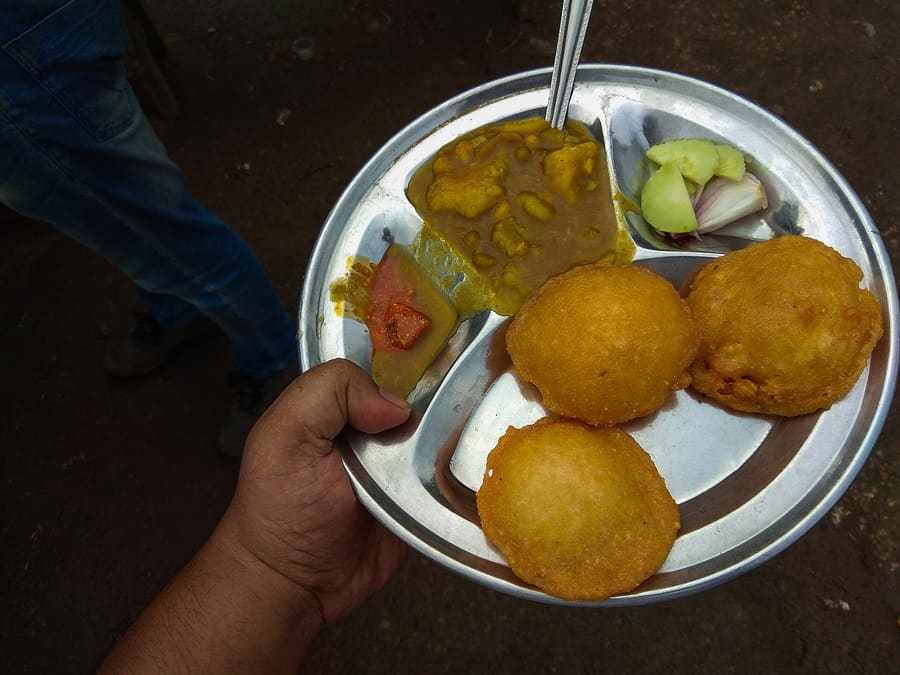Dhuska paired with chana ghugni at a street stall near Upper Bazaar.