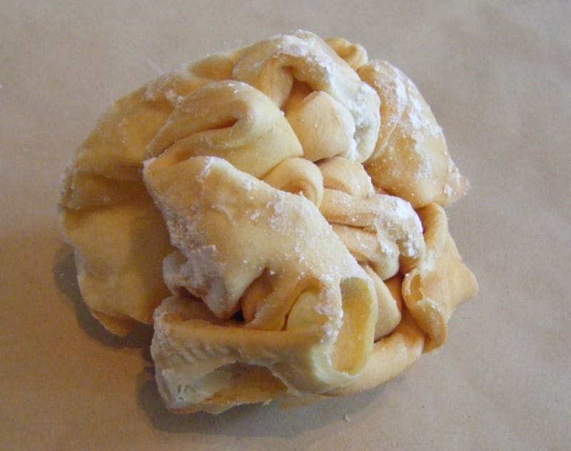 A traditional Schneeball pastry made of fried shortcrust dough dusted with powdered sugar.