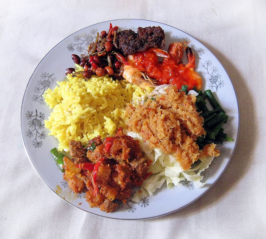 Nasi Kuning Samarinda served with chili-braised fish and boiled egg.