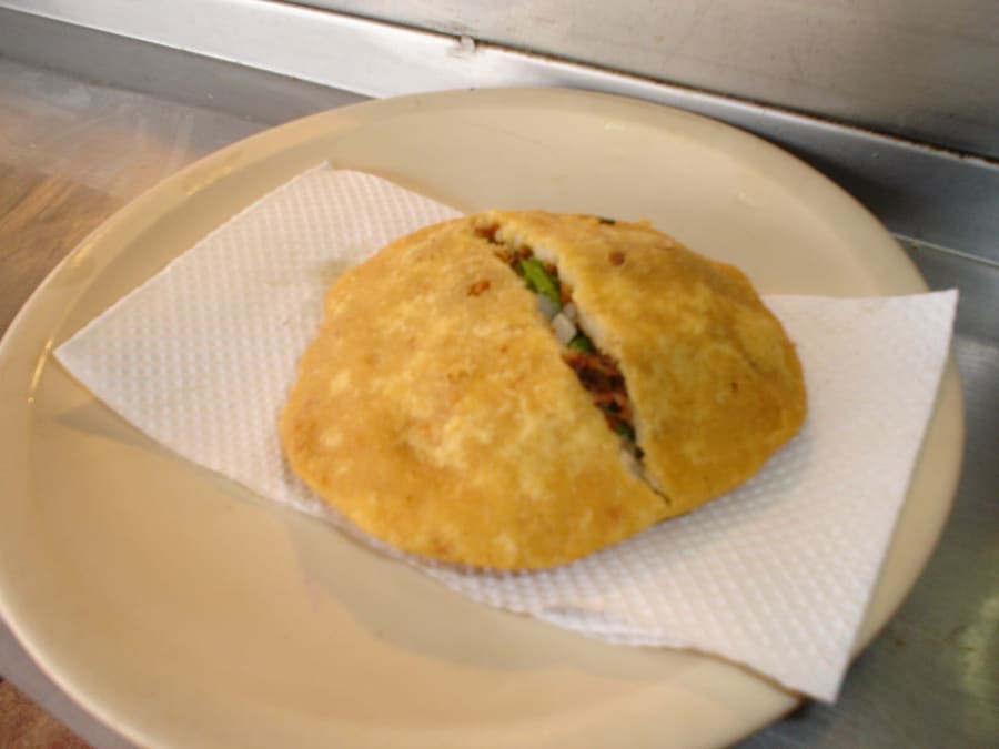 Thick corn gorditas fried with pork migajas at Mercado de la Cruz.