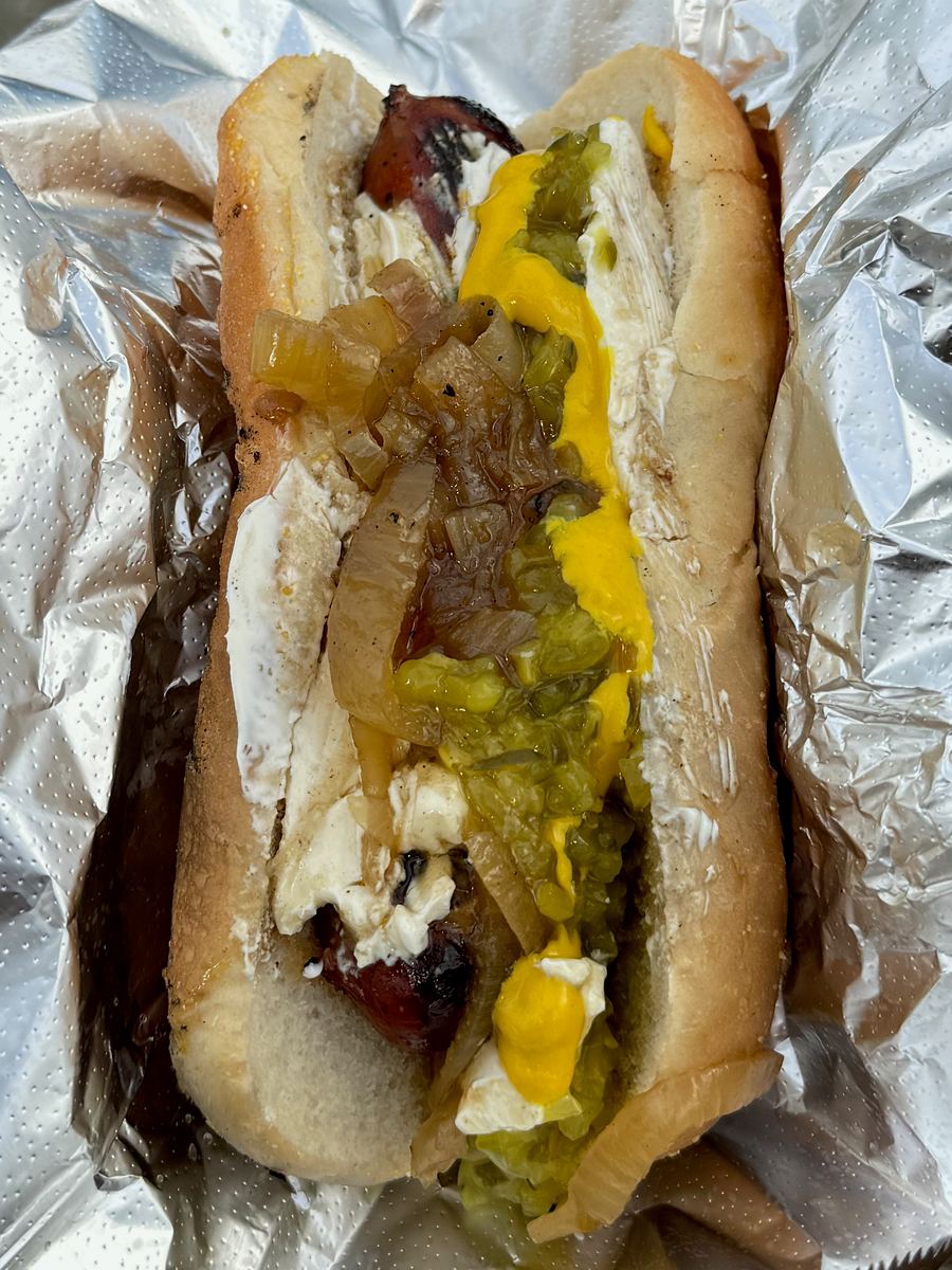 A Seattle-style hot dog topped with cream cheese and grilled onions, served late-night.