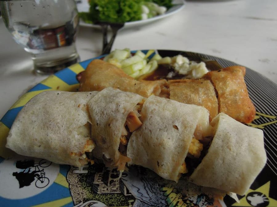 Lunpia Semarang served fresh or deep-fried with sweet garlic gravy, fresh scallions, and green chilies.
