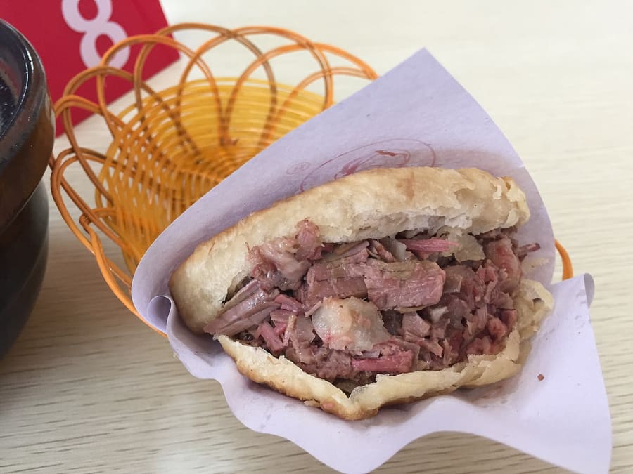 Wuji-style donkey burger stuffed into warm, flaky round flatbread.