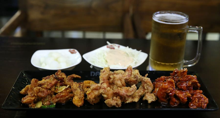 Iron cauldrons deliver super-crisp skin along Suwon Chicken Street.