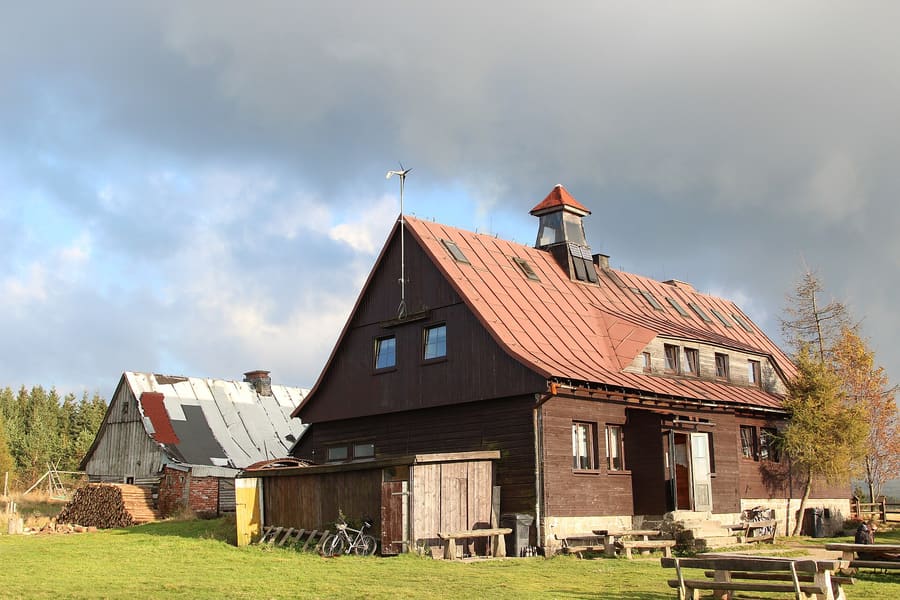 Traditional Silesian dumplings served alongside roasted meat in a local wooden hut.