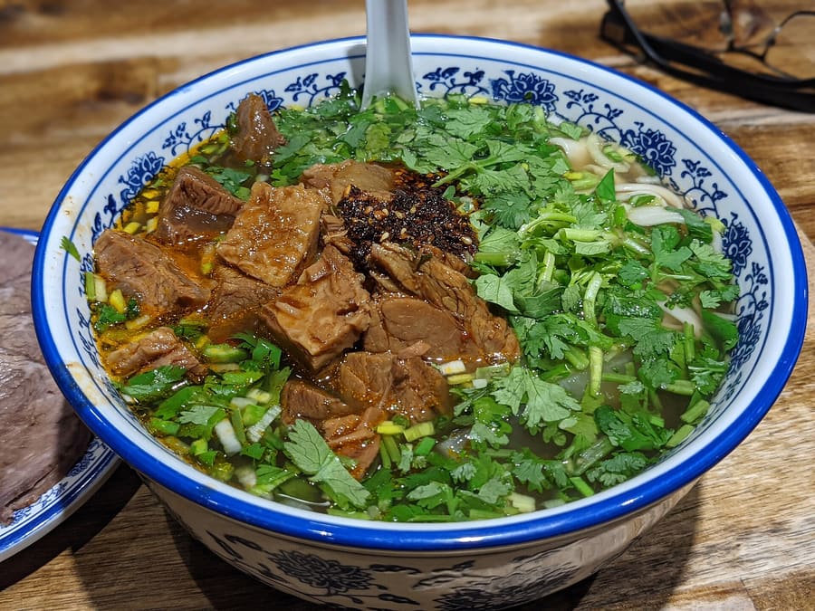 Niurou mian served with tender braised shank and mustard greens.