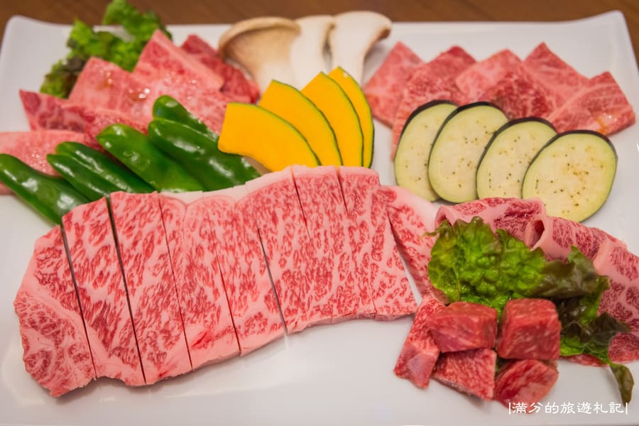 A grilled Hida beef skewer seasoned with coarse salt, sold at a walk-up stall in Sanmachi.