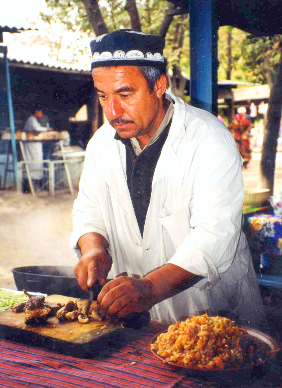 Fresh non flatbread and meat skewers grilled over coals at Chorsu Bazaar.