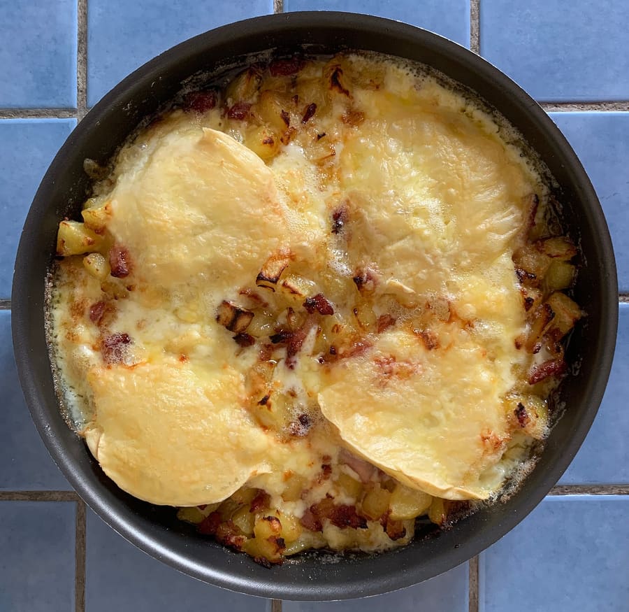 Tartiflette made with potatoes, reblochon cheese, and lardons.