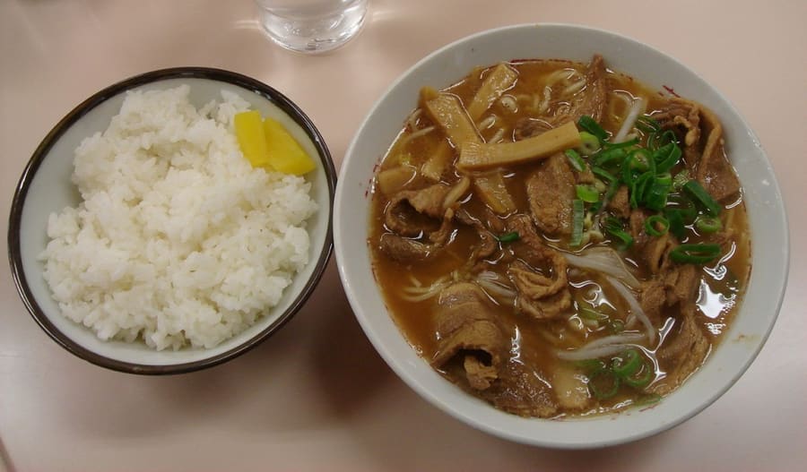 Tokushima ramen served with braised pork belly slices and a raw egg.