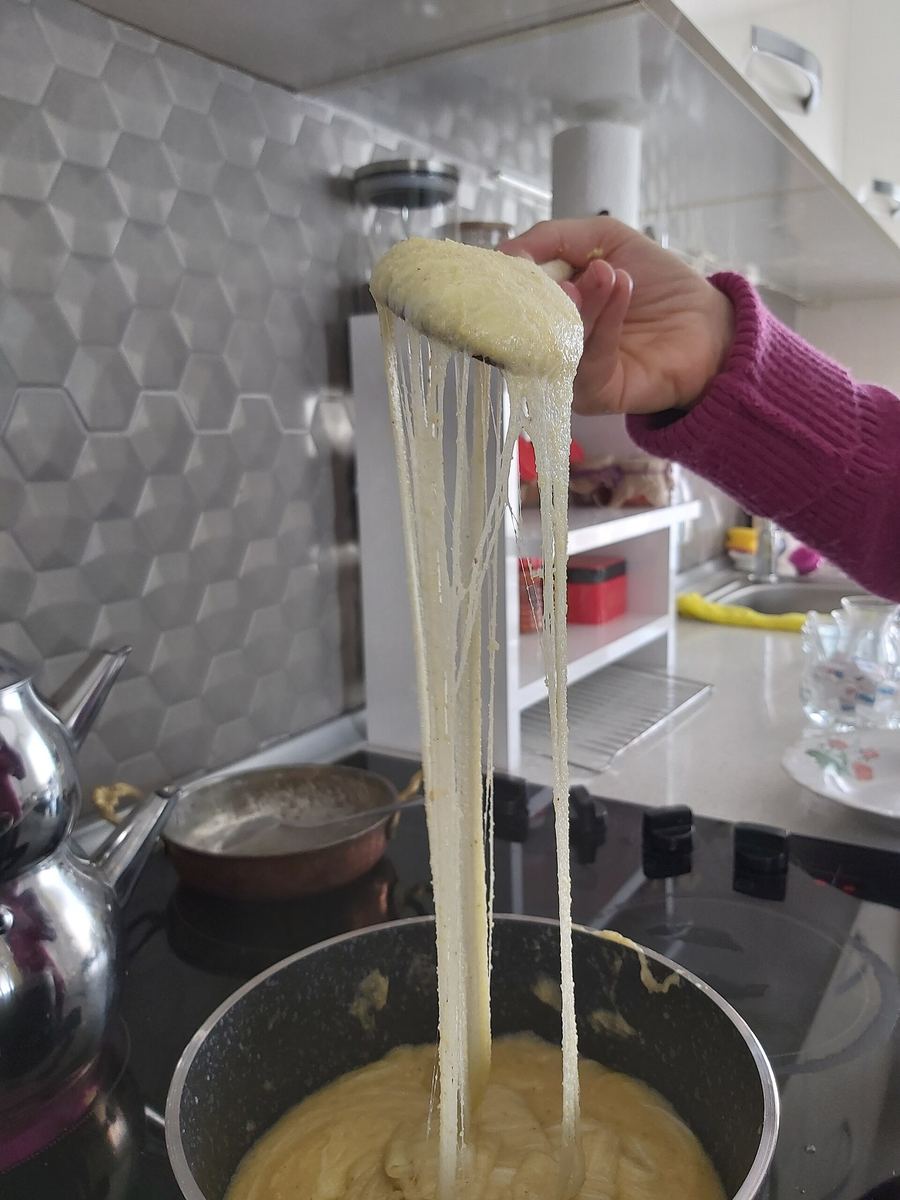Kuymak served bubbling hot in a traditional copper sahan skillet.