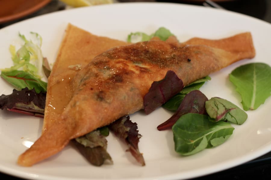 A crispy deep-fried brik pastry containing a runny egg and tuna.
