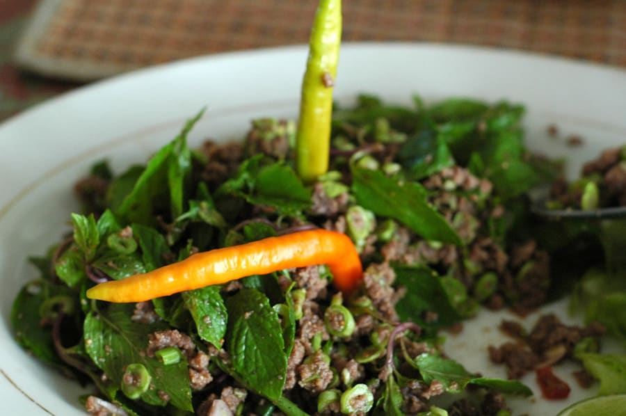 Traditional minced pork lap served with fresh herbs.