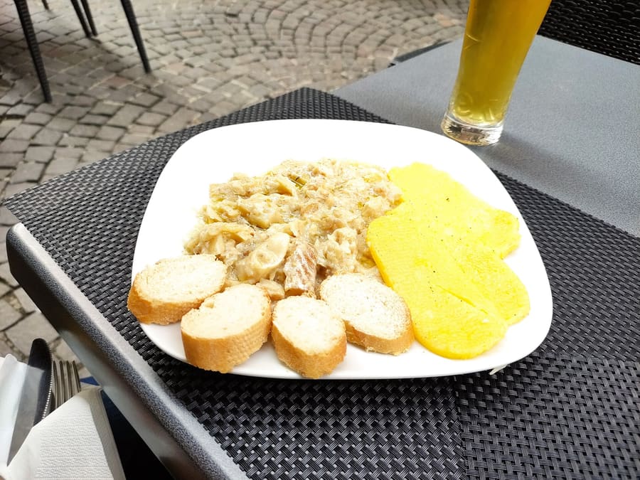 Baccalà alla vicentina slow-simmered and served over yellow polenta.
