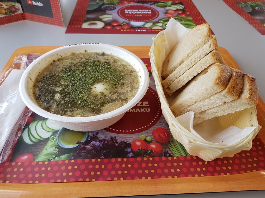 Żurek sour rye soup served with sausage and boiled egg.