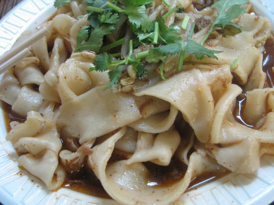 Biangbiang noodles served with chili powder, hot oil, and seared garlic.