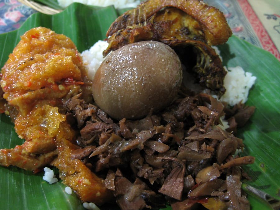 Gudeg Yu Djum, served with egg, chicken, and spicy krecek skin stew.